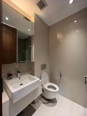 Modern bathroom with white fixtures and glass shower