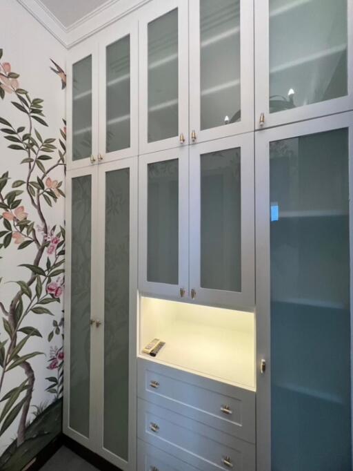 Spacious wardrobe with floral wallpaper