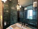 Modern bathroom with green tiles and large mirror