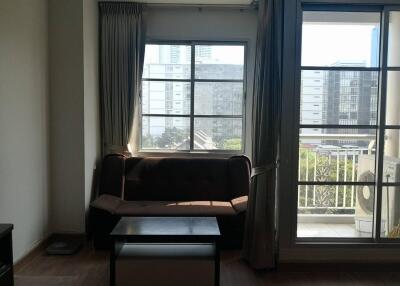 Living room with large window and balcony view