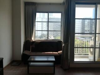 Living room with large window and balcony view