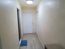 Well-lit hallway with wooden flooring