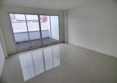 Spacious empty living room with large windows