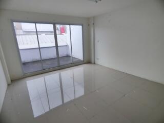 Spacious empty living room with large windows