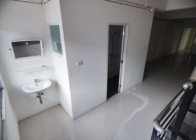 Minimalist bathroom area with sink and mirror