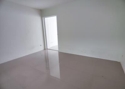 Empty room with glossy floor and white walls