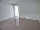 Empty room with glossy floor and white walls