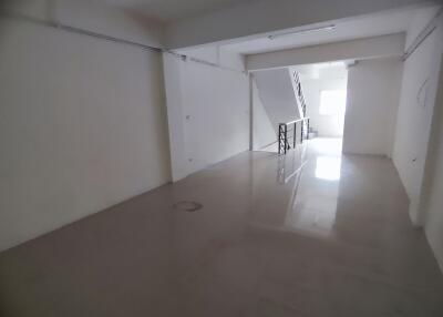 Spacious living area with tiled flooring and natural light