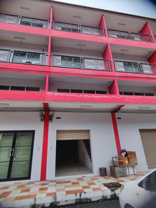 Four-story building with red and white facade