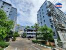 exterior view of apartment buildings with surrounding greenery