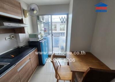 Small kitchen area with appliances and table