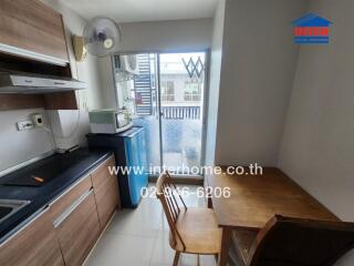 Small kitchen area with appliances and table