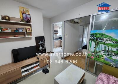 Modern living room with television and floating shelves