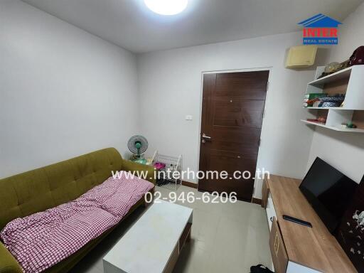 Cozy living room with a green sofa and a wooden door