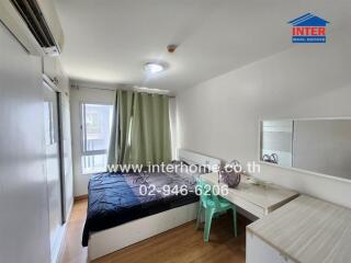 Spacious bedroom with desk, bed, air-conditioning and window