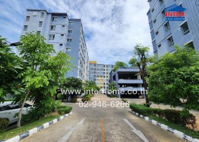 Exterior view of residential buildings with greenery and pathway