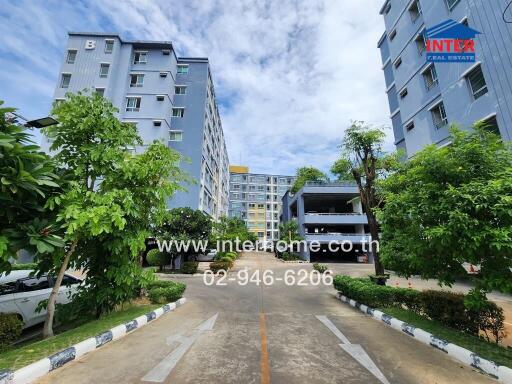 Exterior view of residential buildings with greenery and pathway