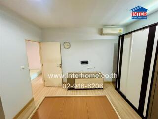 Empty bedroom with air conditioner and modern wardrobe