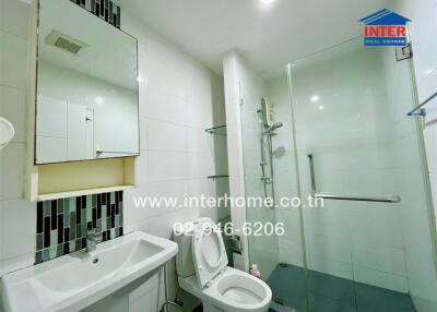 Modern bathroom with glass shower enclosure and white sink