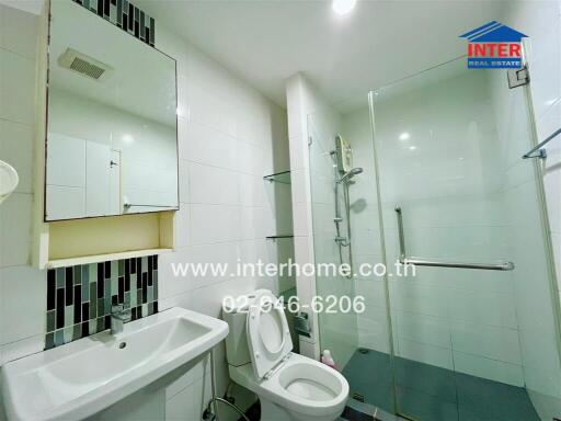 Modern bathroom with glass shower enclosure and white sink