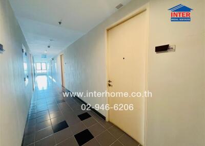 Bright hallway with tile flooring and multiple doors