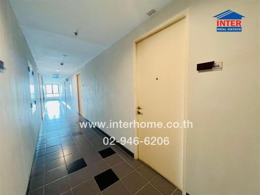 Bright hallway with tile flooring and multiple doors