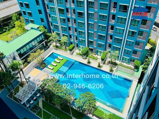 Aerial view of a modern building with a swimming pool