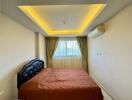 Bedroom with bed and concealed lighting