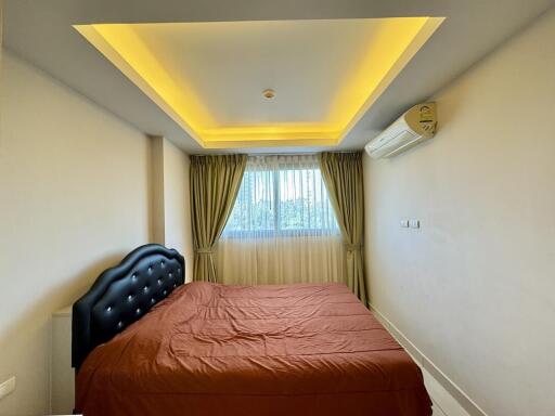 Bedroom with modern lighting and brown bed cover