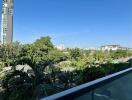 Balcony with a view of greenery and cityscape