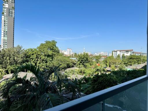 Balcony with a view of greenery and cityscape