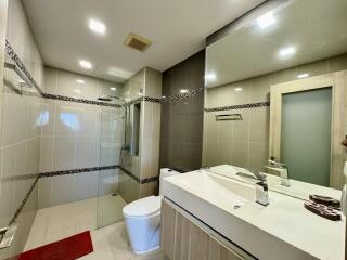 Modern bathroom with shower and large mirror