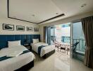 Bedroom with two single beds, balcony view, and modern decor