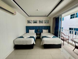 Modern bedroom with twin beds and balcony