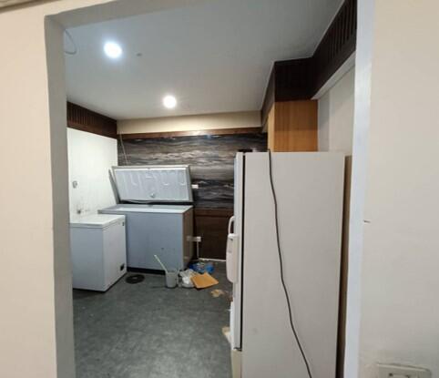 Small kitchen with appliances and dark wood accents