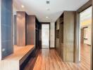 Spacious modern walk-in closet with wooden shelves and drawers