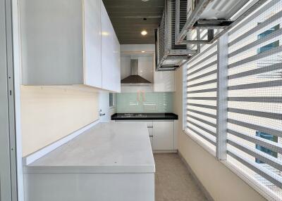 Modern kitchen with white cabinets, electric stove, and ample natural light