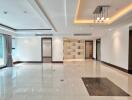 Spacious modern living room with tiled floor, large windows, and ceiling lights