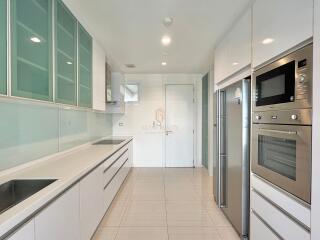 Modern kitchen with built-in appliances and sleek cabinetry