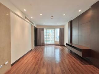 Spacious and modern living room with large window and wooden floor