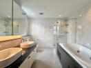 Modern bathroom with double sinks and a large bathtub