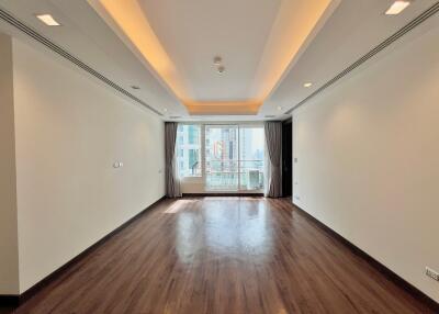 Spacious living room with large window and wooden floor