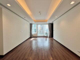 Spacious living room with large window and wooden floor