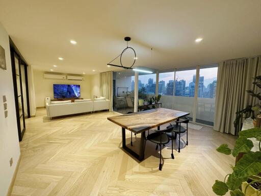 Spacious and modern living room with dining area and city view