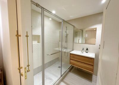 Modern bathroom with a glass-enclosed shower and a wooden vanity