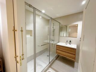 Modern bathroom with a glass-enclosed shower and a wooden vanity