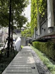 Pathway in front of a building with greenery