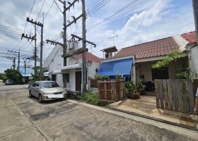 Street view of residential area with houses and car