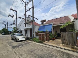 Street view of residential area with houses and car