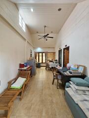 Living room with dining area and high ceiling